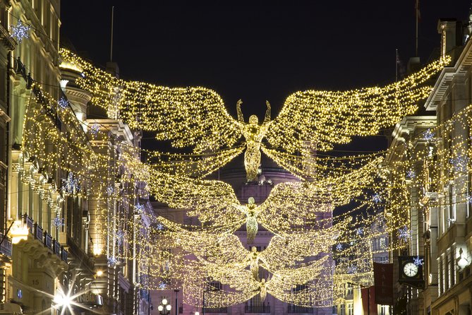 Golden angel lights strung the length of a London street in December