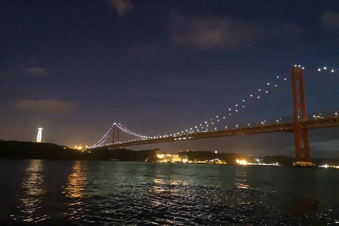 Passing the Year in a Boat with Champagne and Fireworks - Cristo Rei and the 25 de Abril Bridge after dark